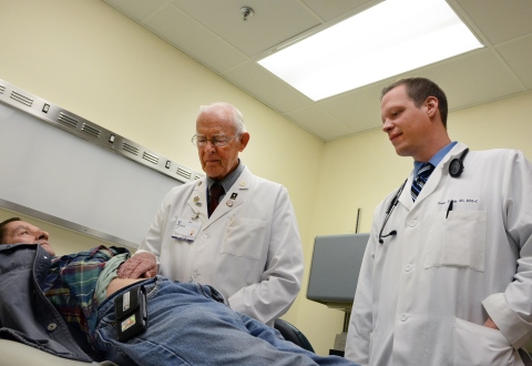 Dr. Hilliard Seigler examines a Veteran as Physician's Assistant Kevin Dendy looks on.  Seigler is VA's oldest Veteran employee