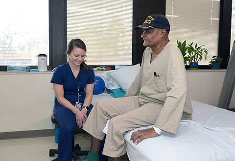 A Durham VAMC Provider works with a geriatric patient at bedside