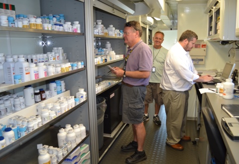 Pharmacy technicians prepare the mobile pharmacy to distribute medications to Veterans in Tarboro, N.C.