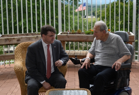 VA Secretary Robert Wilkie and retired General Leo Lacasse chat on the Salem CLC Porch