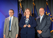 Asheville director Steph Young (center) standing with VISN 6 director Paul Crews (right) to receive the VHA Best Experience Award for facility complexity level 1 from Dr. Steven Lieberman