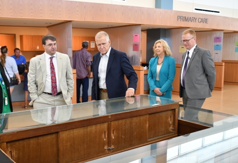 VA Secretary Robert Wilkie (left) and Sen. Thom Tillis (R, N.C.) stop to admire a display case containing Veterans’ memorabilia in the lobby of the Wilmington Heath Care Center. They are flanked by VISN 6 Director DeAnne Seekins (2nd from right) and Fayetteville VA Director Daniel Dücker (ri